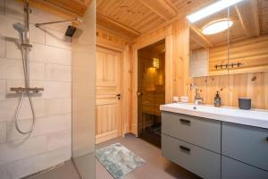 a bathroom with a sink and a shower at Moose Lodge - 6p - With Sauna & Water View in Vradal +45 photos
