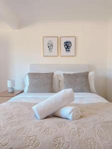 a bedroom with a bed with two pillows at Comfy unit near Garden City Westfield Street Parking in Brisbane