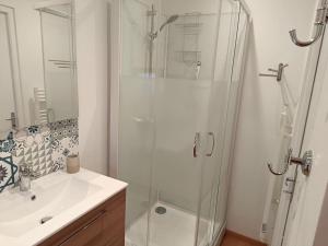 a bathroom with a glass shower and a sink at Charmant Chalet de montagne in Picherande +31 photos