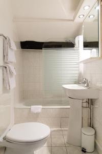 a bathroom with a sink and a toilet and a tub at D'win in Paris +60 photos
