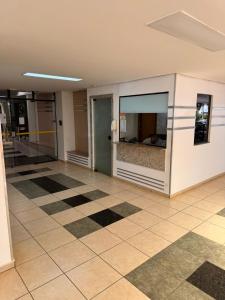 an empty lobby with a bed in a window at Flat Sudoeste Ed. Leonardo Center by CentoEdez in Brasília