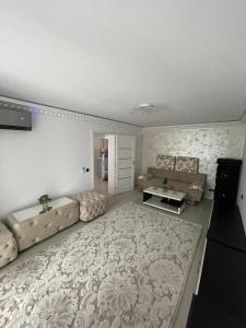 a living room with a couch and a table at Laura House in Simeria