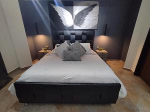 a bedroom with a bed with white sheets and birds on the wall at R Apartamento de lujo en Valencia 1 Hab in Valencia
