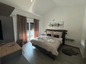 a bedroom with a bed and a table and a television at Villa Mario in Poreč +13 photos