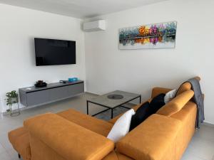 a living room with a couch and a flat screen tv at Villa Mario in Poreč
