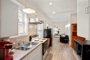 a kitchen with a sink and a refrigerator at Cozy Retreat on Commercial Street for 2 in Provincetown