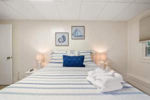 a bedroom with a bed with blue and white stripes at Cozy Retreat on Commercial Street for 2 in Provincetown
