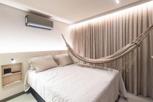 a bedroom with a hammock bed in front of a window at Way Tambaú #P2 - Triplo deluxe por Carpediem in Tambaú +52 photos