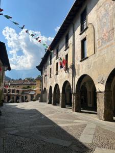 a building with prayer flags in a street at Monolocale All'orologio in Clusone