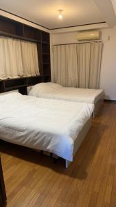 Postel nebo postele na pokoji v ubytování Jl千住別荘