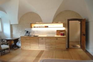 a kitchen with a sink and a wooden cabinet at Schloss Hofstetten Ingerle-Klause in Hofstetten