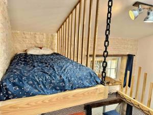 a bedroom with a swing bed in a room at L'atelier - Duplex Gîte de charme avec Spa La Rochelle in Saint-Médard-dʼAunis