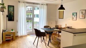 a kitchen and dining room with a table and chairs at Weissach Apartments in Kreuth