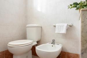 a bathroom with a toilet and a sink at Chez Dione in Siracusa +25 photos