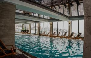 a large swimming pool with chairs in a building at Milmari resort N12 in Kopaonik