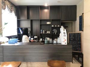 a woman sitting at a counter in a coffee shop at Chengdu Sichuan University Budget Hotel in Chengdu