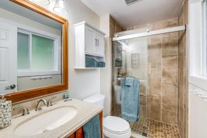 a bathroom with a sink and a toilet and a shower at Bremerton Home with Fire Pit Near Parks and Museums in Bremerton +20 photos