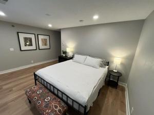 a bedroom with a large white bed and two lamps at Aksarben Area 2 BD-2 BA by UNO in Omaha