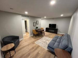 a living room with a couch and chairs and a table at Aksarben Area 2 BD-2 BA by UNO in Omaha