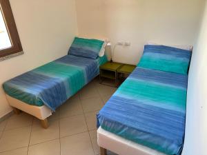 Postel nebo postele na pokoji v ubytování Casa Luna a Porto Pino