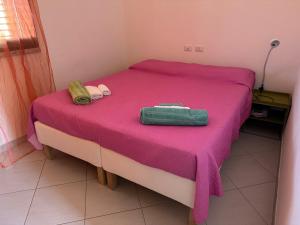Postel nebo postele na pokoji v ubytování Casa Luna a Porto Pino