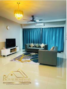 a living room with a couch and a tv at Royal Homestay Palm Garden in Lahad Datu +15 photos