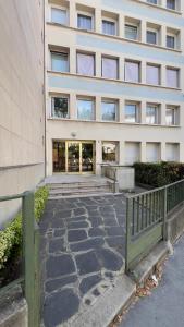 a building with a stone walkway in front of a building at PS5, Cinéma & Jacuzzi - Skyline Luxe in Saint-Étienne