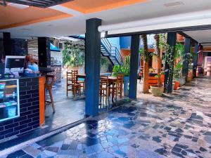 a restaurant with a table and chairs on a patio at Hostel Gravatá in Piracicaba