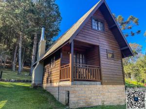 a log cabin with a porch and a deck at Cabanas em Canela - Leão da Tribo de Judá- Refúgio com Piscina in Canela