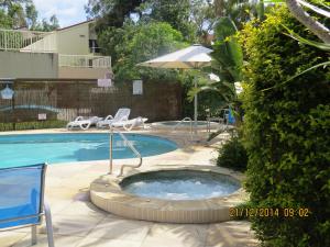 a pool with a hot tub in a yard at Noosa Keys Resort in Noosaville