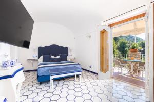 a bedroom with a bed and a sliding glass door at Villa Nannina in Positano