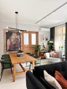 a living room with a table and a couch at Apartament Pracownia in Bydgoszcz +22 photos