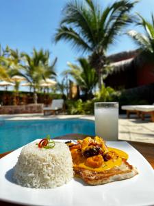 a plate of rice and cake with a glass of milk at El Mirador de Vichayito in Vichayito
