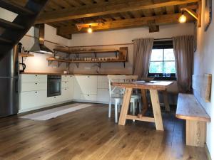 a kitchen with a wooden table in a room at Chalupa Grúnik in Zázrivá