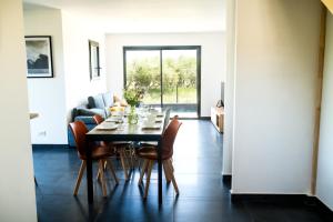 a dining room with a table and chairs at Villa laudun in Laudun +5 photos