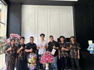 a group of people posing for a picture with flowers at Cozy Furnished Studio Apartemen Transpark Cibubur by Royal Home Indonesia in Kalimanggis