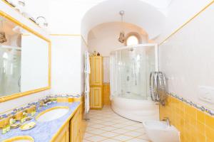 a bathroom with two sinks and a bath tub at Villa Nannina in Positano +37 photos