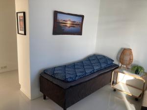 a bed in a room with a picture on the wall at Rovaniemi center apartment in Rovaniemi