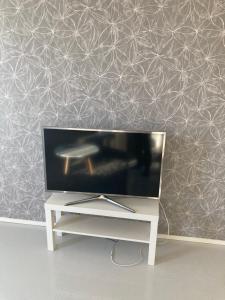 a flat screen tv sitting on top of a white table at Rovaniemi center apartment in Rovaniemi