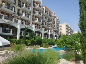 a large apartment building with a pool in front of it at Harmony Suites 11 Grand Resort in Sunny Beach