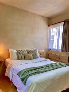 Postel nebo postele na pokoji v ubytování Hotel Casa Maakjä