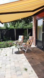 two chairs and a table on a patio at BIESBOSCHBEST in Werkendam