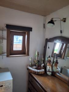 a bathroom with a mirror and a wooden dresser at Le petit nid in Brugelette +9 photos