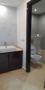 a bathroom with a sink and a toilet at EuroStar Appartement in Casablanca