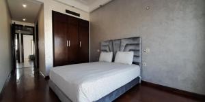 a bedroom with a large white bed in it at EuroStar Appartement in Casablanca
