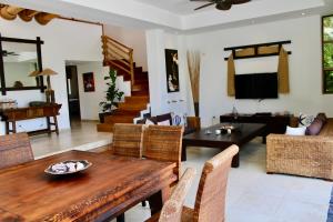 a living room with a wooden table and chairs at VillaFV GuavaBerry-JuanDolio-4BR-6Bds-12Pax-AC-WiFi-BBQ-GolfView in Paraíso