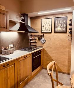 a kitchen with wooden cabinets and a stove top oven at La casa di Teo Pescocostanzo in Pescocostanzo +23 photos