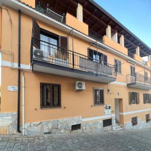 an apartment building with balconies and a patio at Casa Spartea Cilento coast in Marina di Camerota
