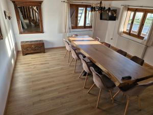 a conference room with a long wooden table and chairs at Emma's Lake Houses in Bîrsana +12 photos