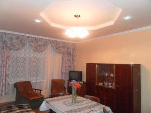 a living room with a table with a vase of flowers at Jermuk Apartment in Jermuk